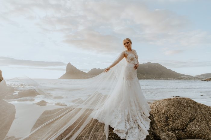 bride on rocks by sea