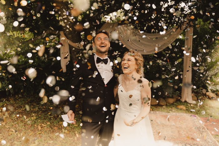 newlywed couple underneath confetti
