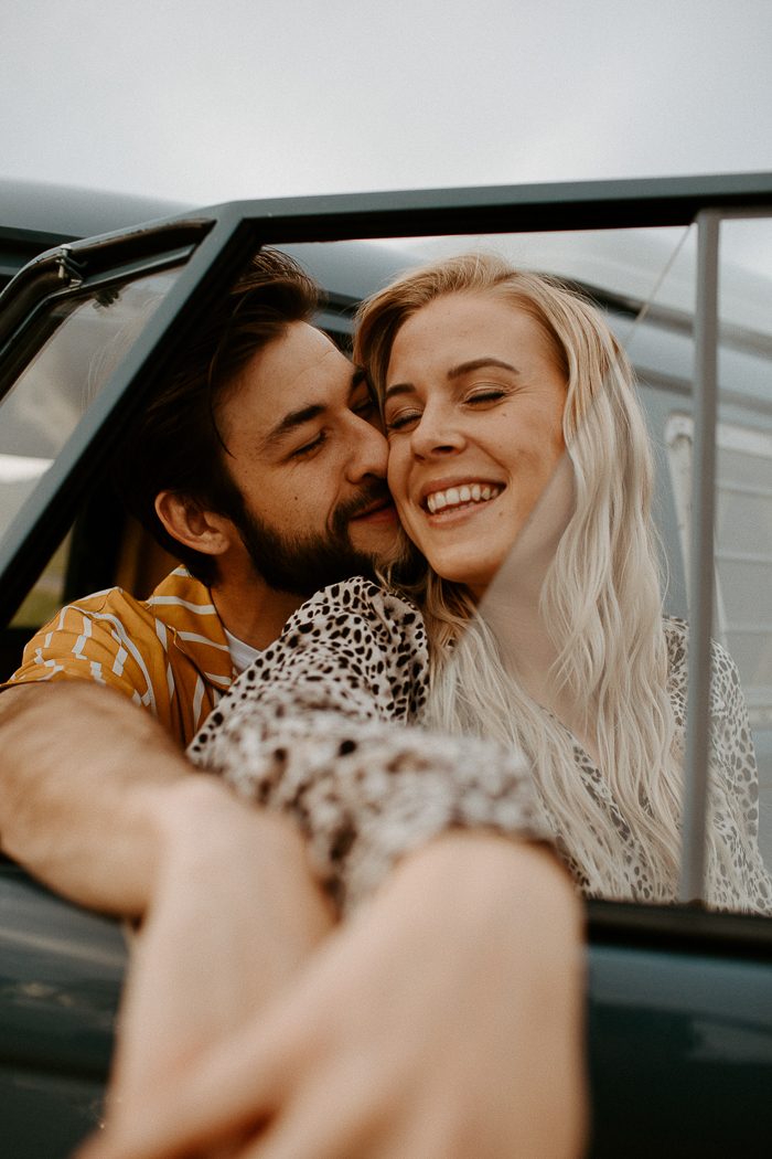 couple leaning out of open car window