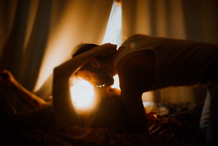 intimate photo couple kissing golden light