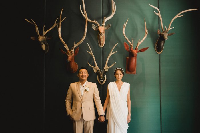 bride and groom with mounted deer