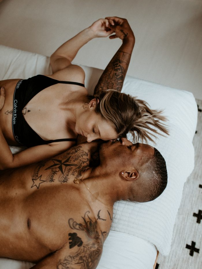 couple laying intimately in bed