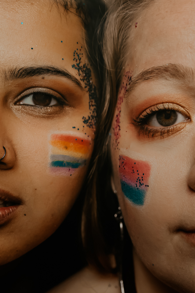 LGBTQ+ couple with painted and glitter faces