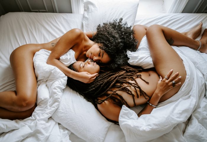 nude couple in bed embracing
