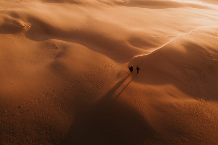 drone shot of couple in desert sands