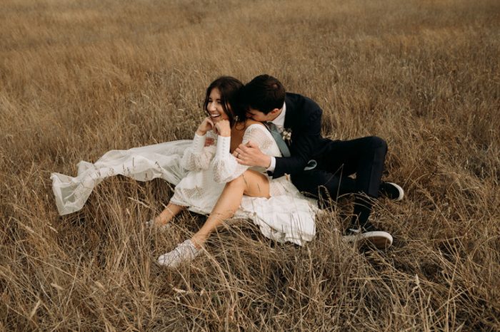 newlyweds in a field