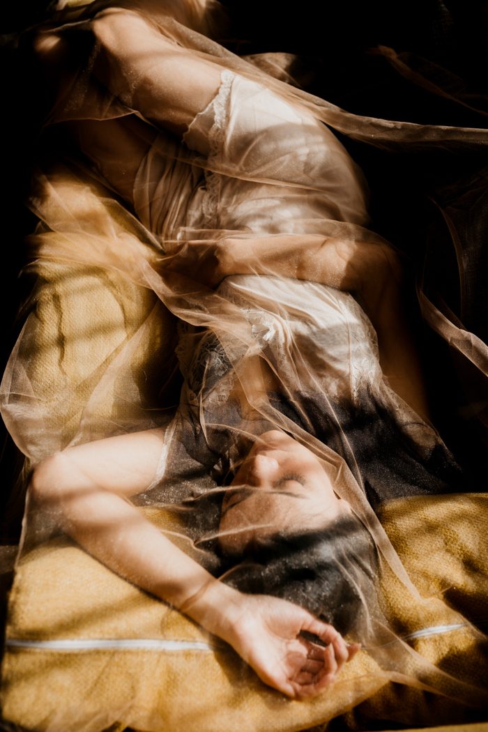 woman lying down with window shadow
