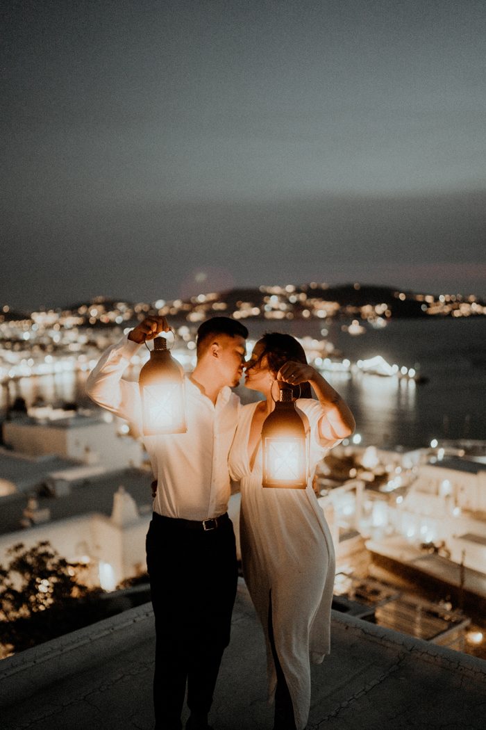 couple with lantern and city lights