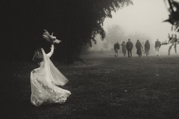 black and white photo bride behind her guests
