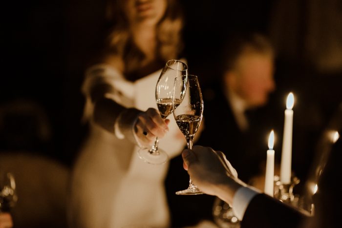 bride and groom cheers wine glasses
