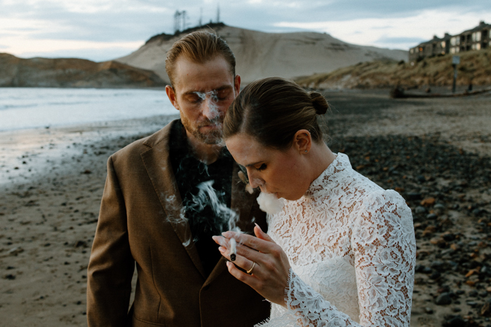 couple smoking on a beach bye 2021