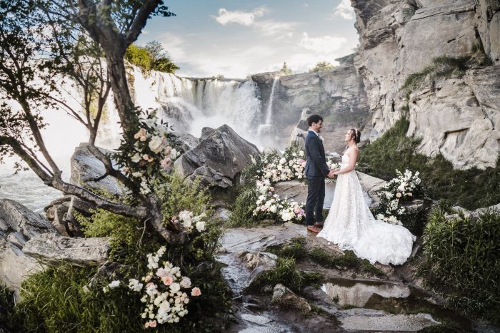 couple landscape portrait in front of Alberta waterfall