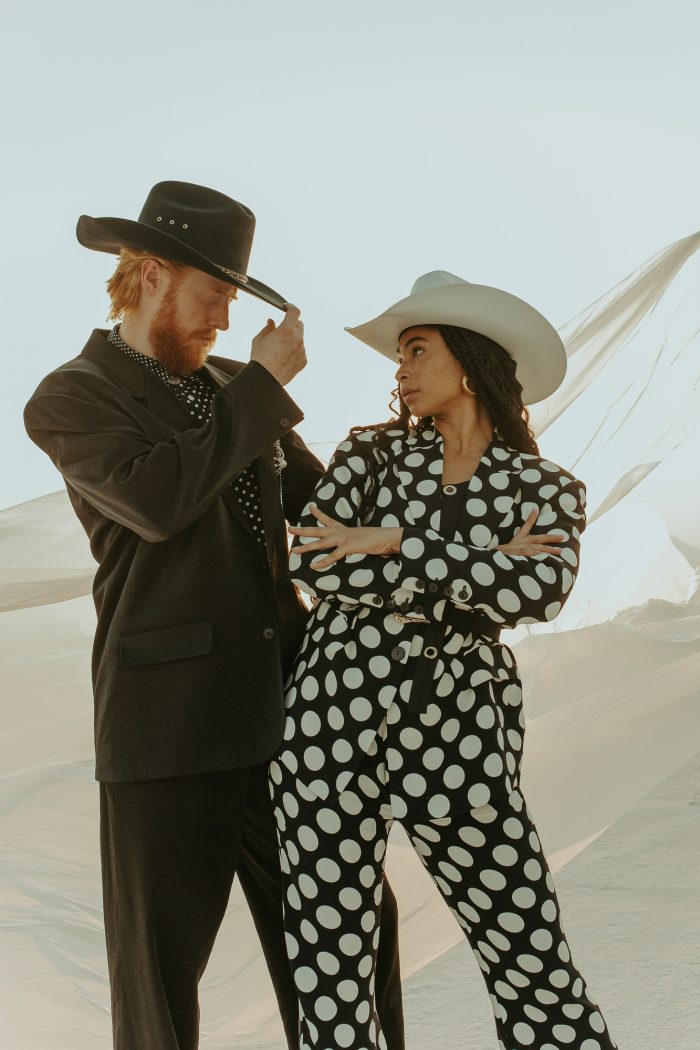 cool couple wearing cowboy hats featuring polkadot suit