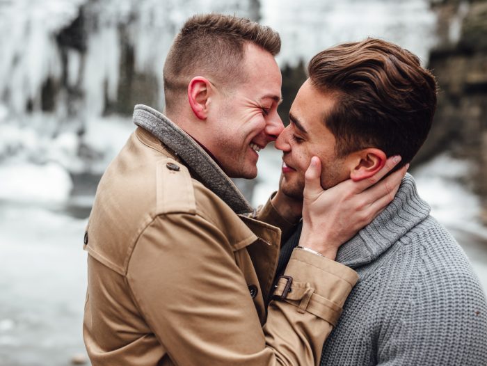 Same-sex couple kissing in the snow 