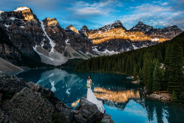 bride standing by Moraine Lake in the Canadian Rockies