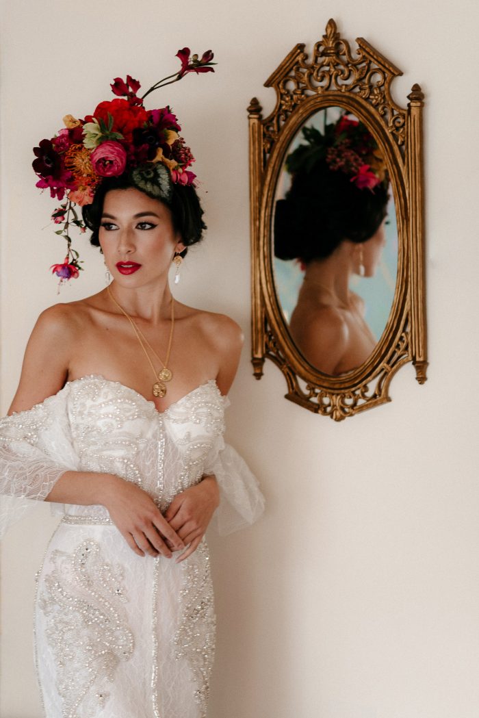 bridal portrait with intricate headpiece and gold mirror