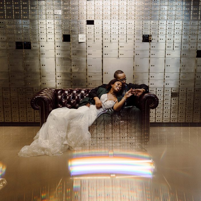 wedding day couple on couch in front of treasury vaults