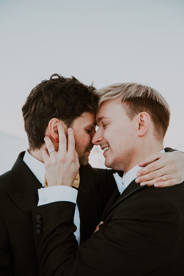 same-sex couple embracing on wedding day
