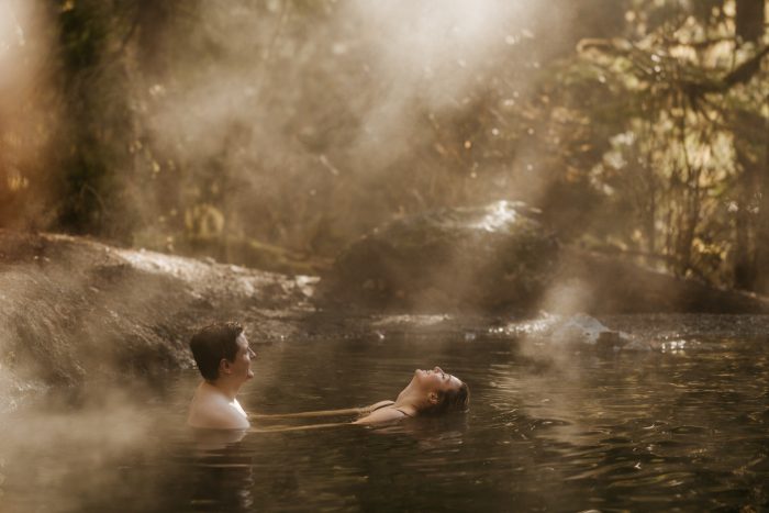 couple in hot springs water with steam