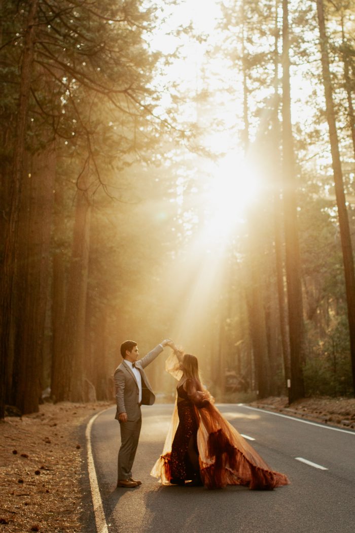 couple dancing in the middle of street with sunbeams