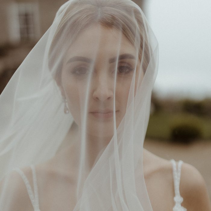 moody bridal portrait behind veil