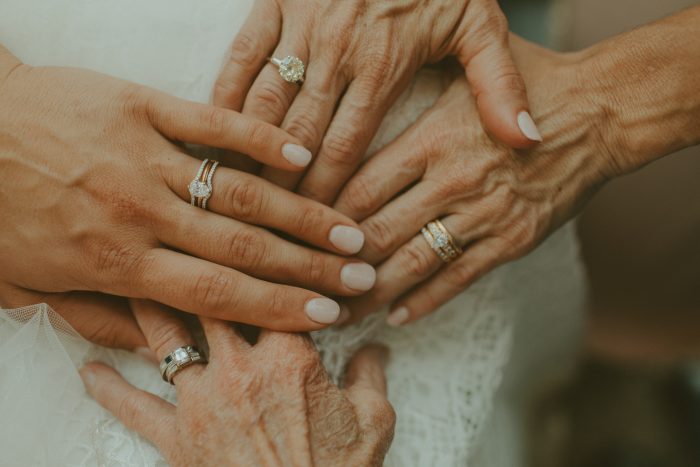 four generations of family showing engagement rings