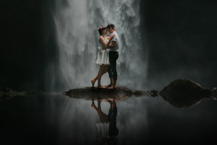 wedding day couple in front of jungle waterfall