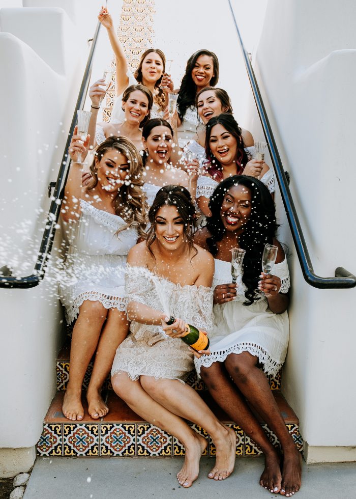 bridesmaids getting ready popping champagne