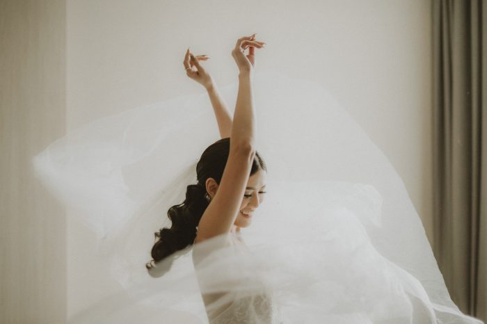 joyful bride spinning in dress and veil