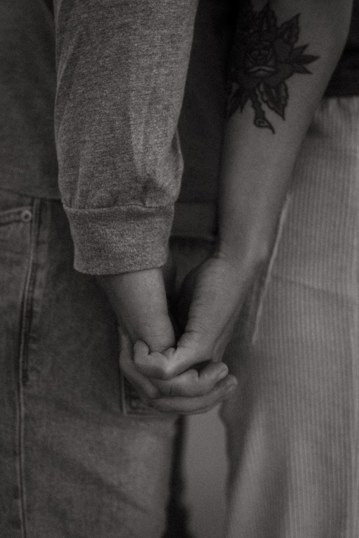 black and white photo of couple holding hands