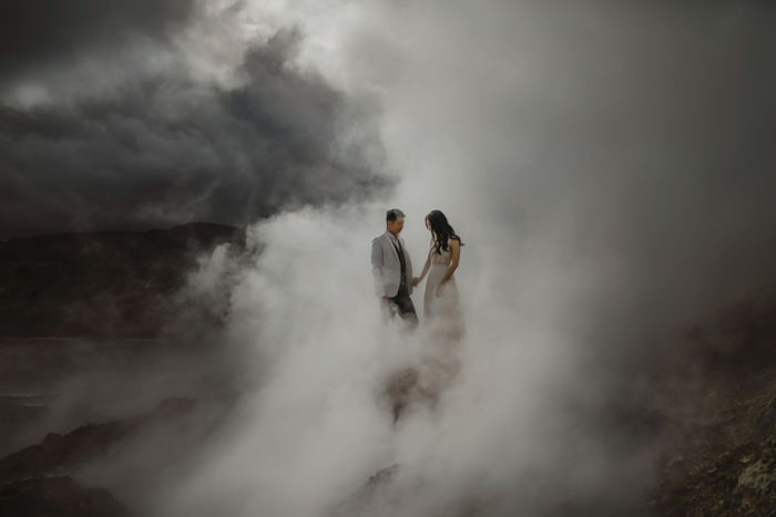 couple holding hands in thick fog