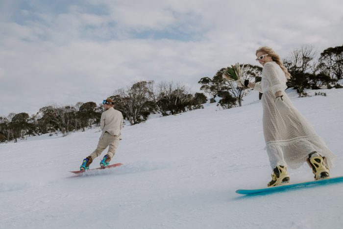 couple snowboarding in Australia after elopement