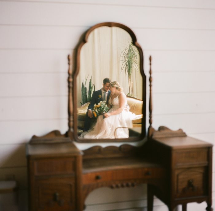 bride and groom reflection in vintage mirror
