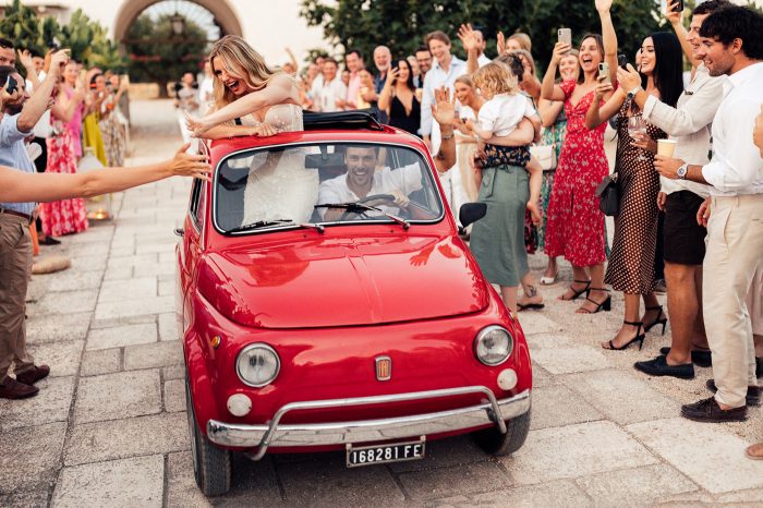 bride and groom exiting wedding in Fiat