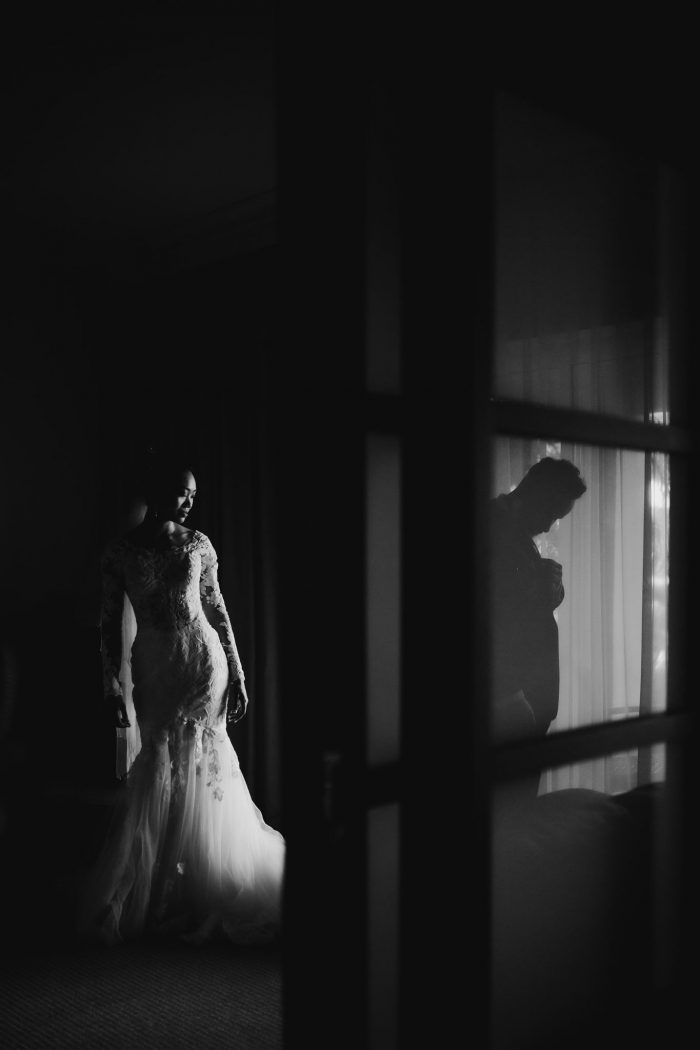 bride and groom getting dressed in adjacent rooms