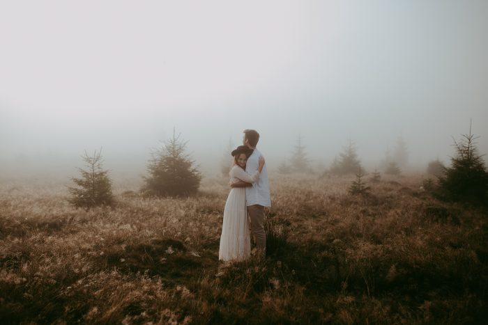 couple in foggy field in Transylvania 