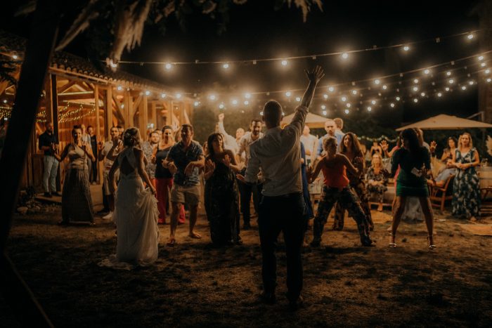 wedding reception at night with dancing and string lights