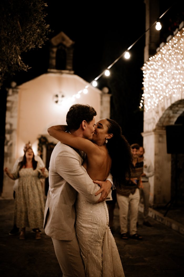 wedding couple kissing under twinkle lights