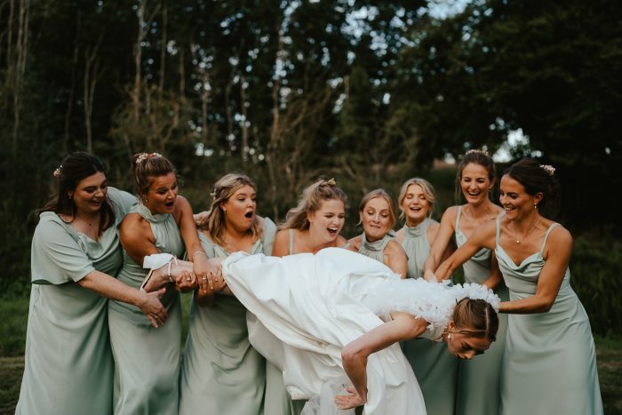 bridemaids dropping bride during photo