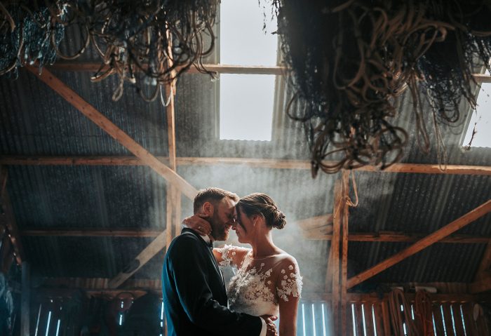wedding day couple in foggy barn