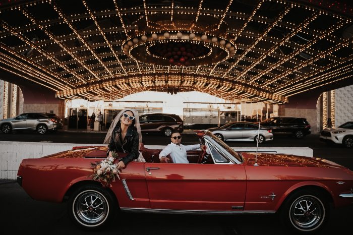 couple in red mustang convertible after Las Vegas wedding