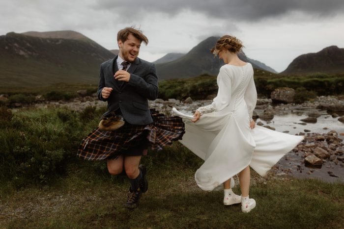 bride and groom twirling in dress and kilt