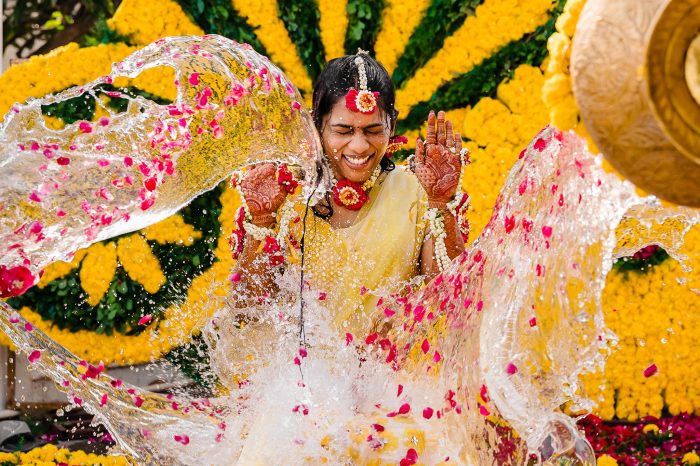 water being splashed on Indian bride