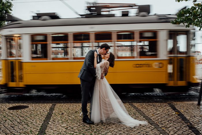 wedding couple kissing in front of streetcar
