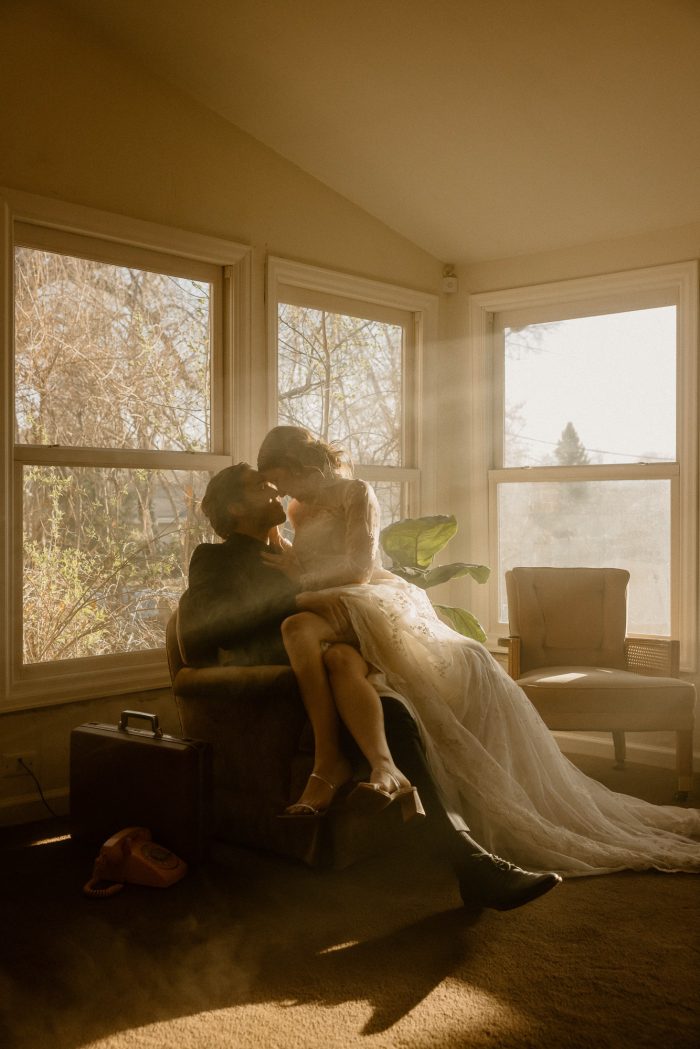wedding couple sitting in vintage living room with sun rays Top Pics February 2023