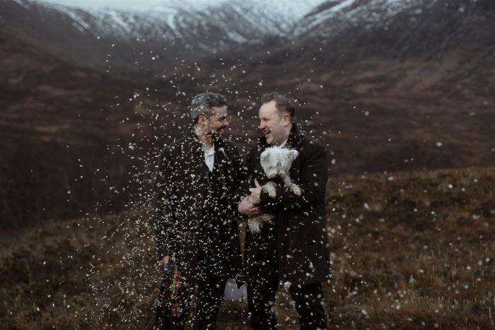 same-sex wedding couple with confetti and West Highland Terrier 