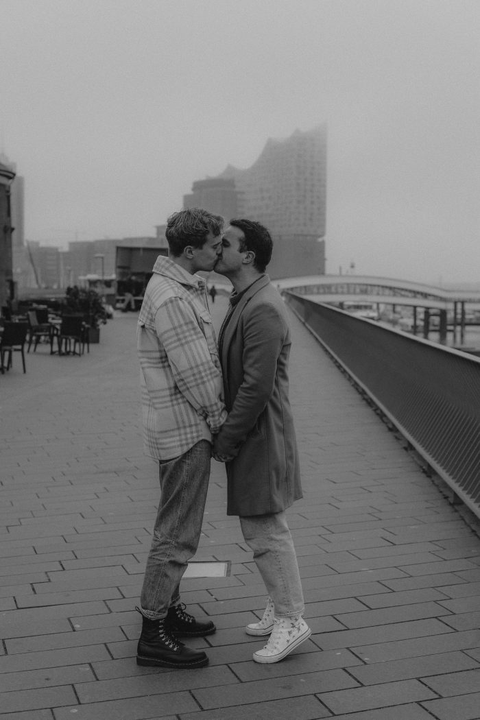 gay couple kissing on a winter city street 