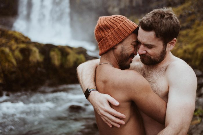 couple embracing by a waterfall