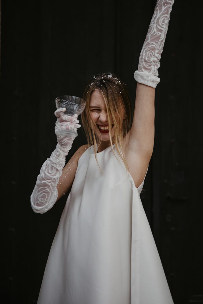 cheerful bride with confetti and sheer gloves