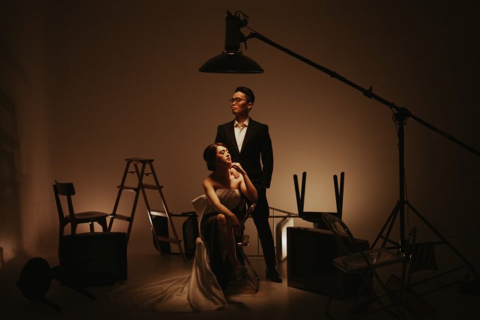 strange studio couple portrait with visible equipment
